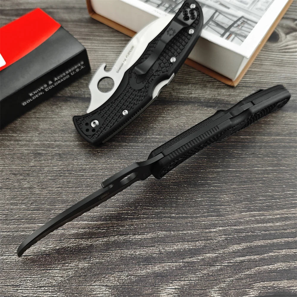 Two Serrated Folding Knives with Hawkbill D2 Blades Durable Textured Nylon Fiber Handles Signature Thumb Hole for Smooth Opening Available in Black and Silver Finishes These Reliable Tools Are Perfect for Everyday Carry Campi