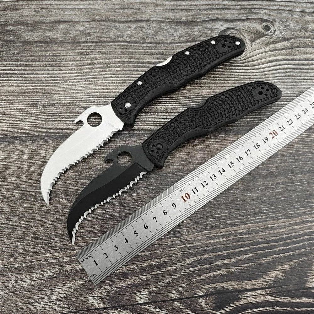 Two Serrated Folding Knives with Hawkbill D2 Blades Durable Textured Nylon Fiber Handles Signature Thumb Hole for Smooth Opening Available in Black and Silver Finishes These Reliable Tools Are Perfect for Everyday Carry Campi