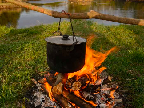 Big pot hanging over campfire